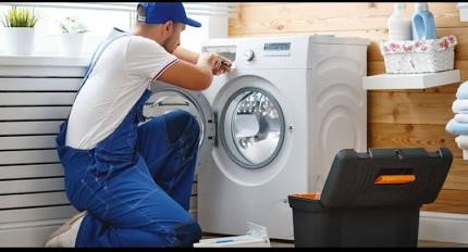 Washing machine repair technician in Hyderabad servicing a front load washing machine